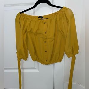Yellow shirt can be worn off the shoulder or regular